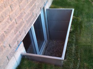 Modern Square Stainless Steel Egress Window Well new install with sod laid around it