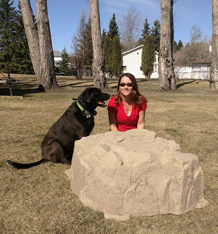 A photo of Jodi from The Rock Company and her Black Lab dog.