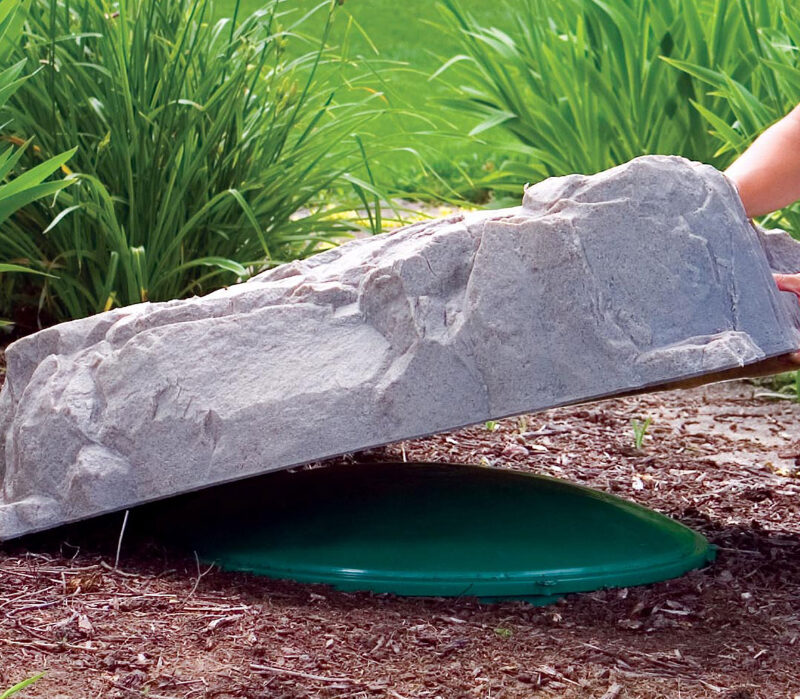 a photo of fauxrocks model 112 being used to cover a sewage cap.