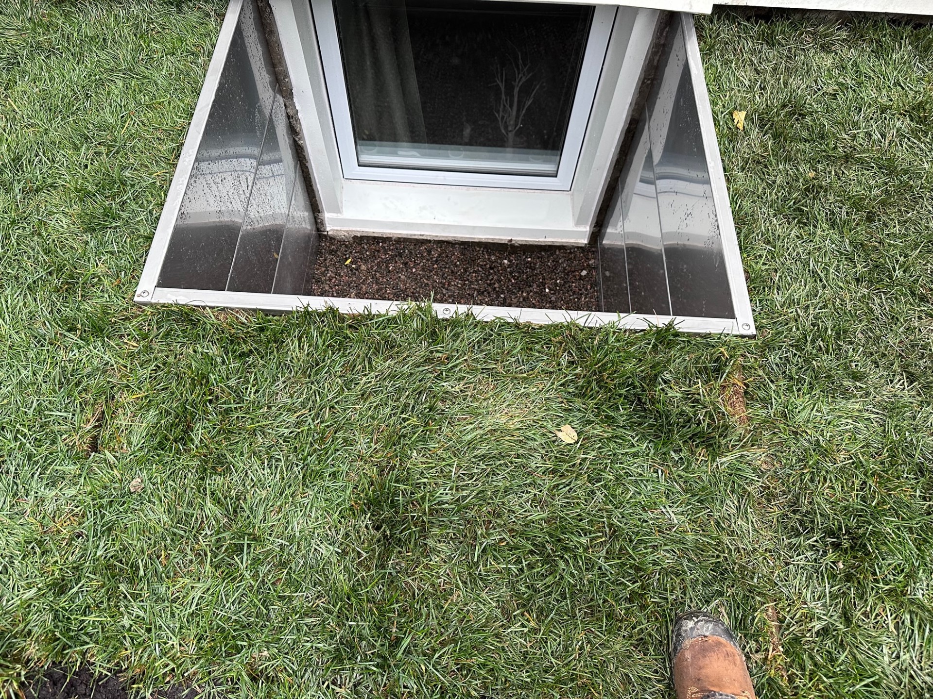 A photo of a very clean and freshly installed modern square window well